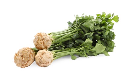 Photo of Fresh raw celery roots with stalks isolated on white