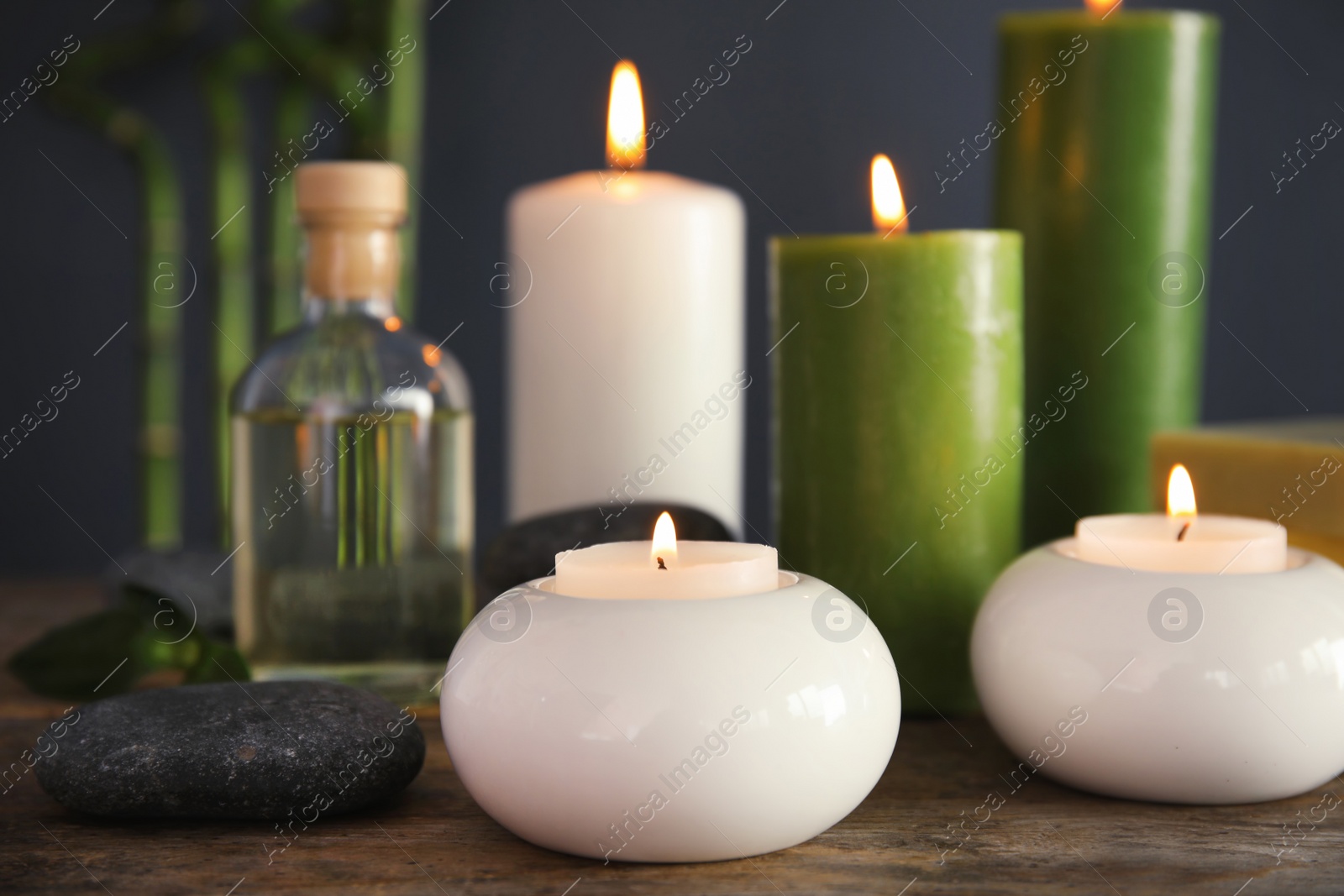 Photo of Spa composition with candles and cosmetic on table