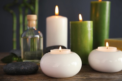 Spa composition with candles and cosmetic on table