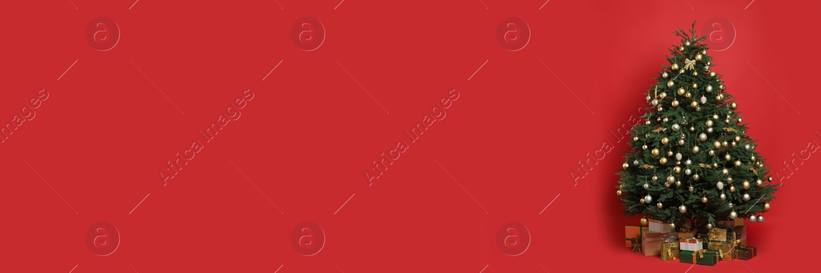 Image of Beautifully decorated Christmas tree and gift boxes on red background, space for text. Banner design