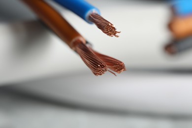 Photo of Colorful electrical wires on blurred background, closeup