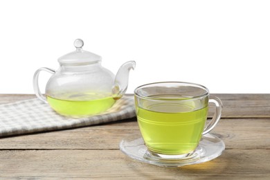 Photo of Refreshing green tea in cup and teapot on wooden table against white background