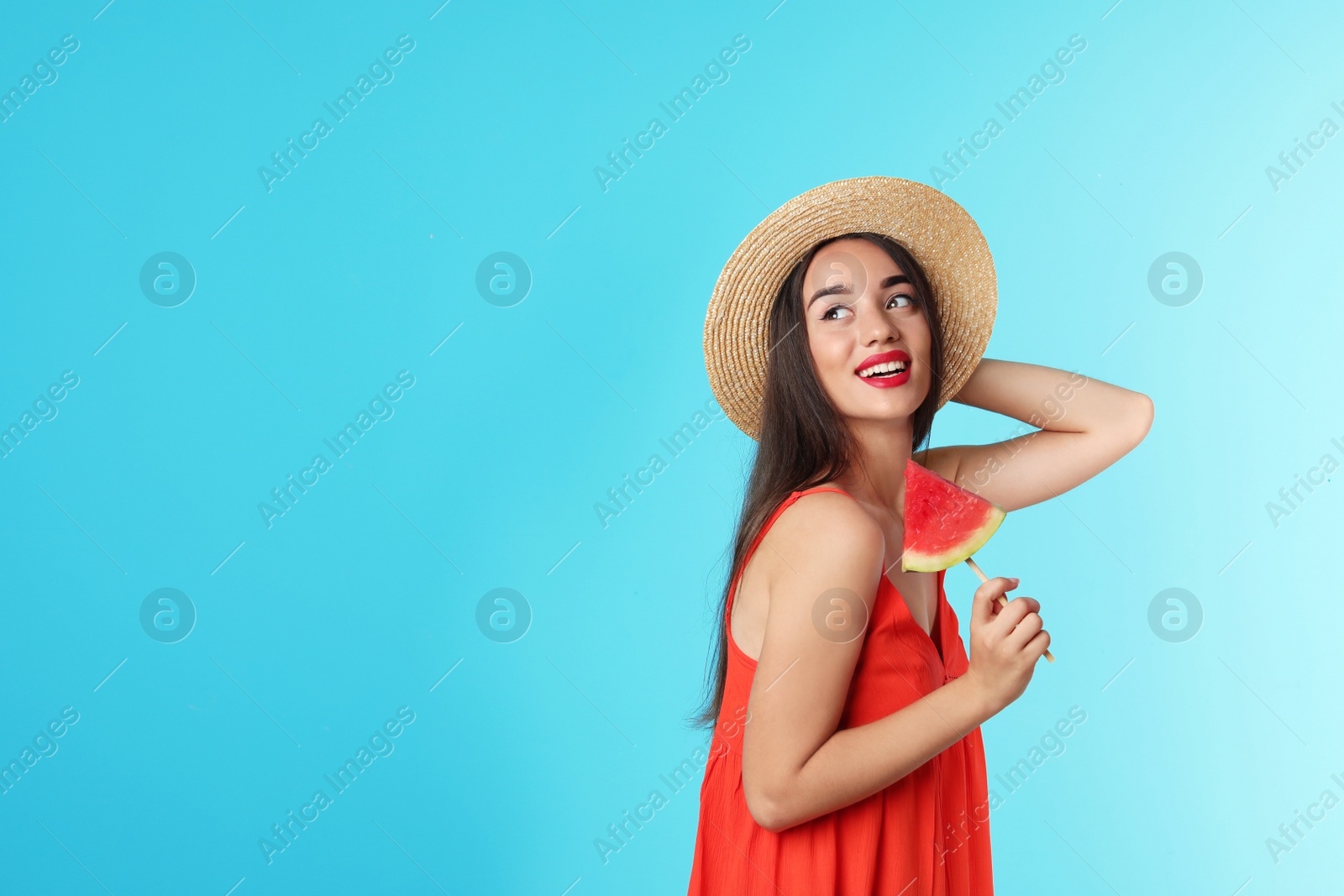 Photo of Beautiful young woman posing with watermelon on color background