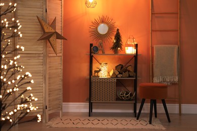 Photo of Beautiful room interior with Christmas decor on shelving unit