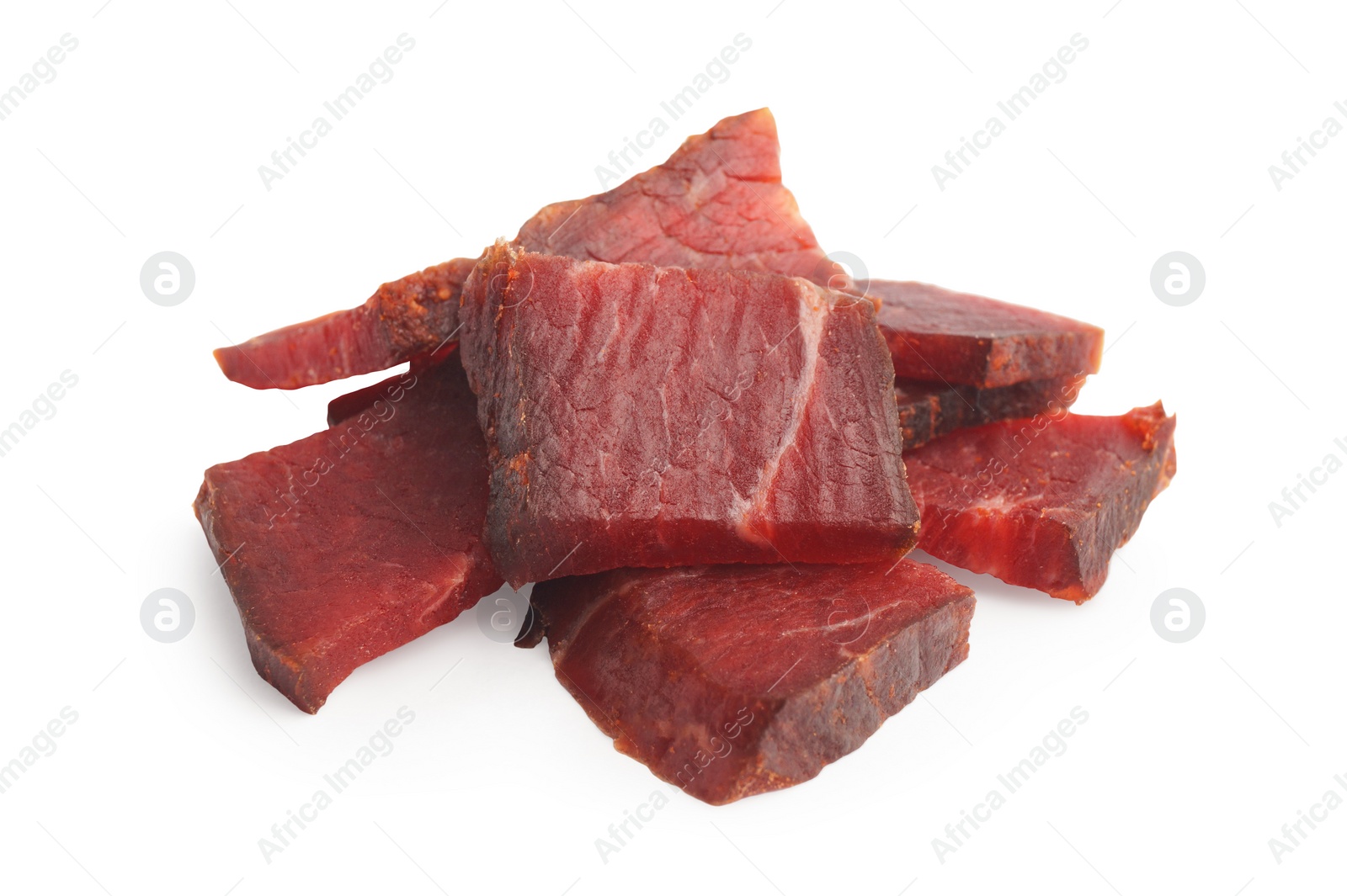 Photo of Pieces of delicious beef jerky on white background