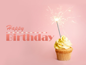 Text Happy Birthday and delicious cupcake with sparkler on pink background