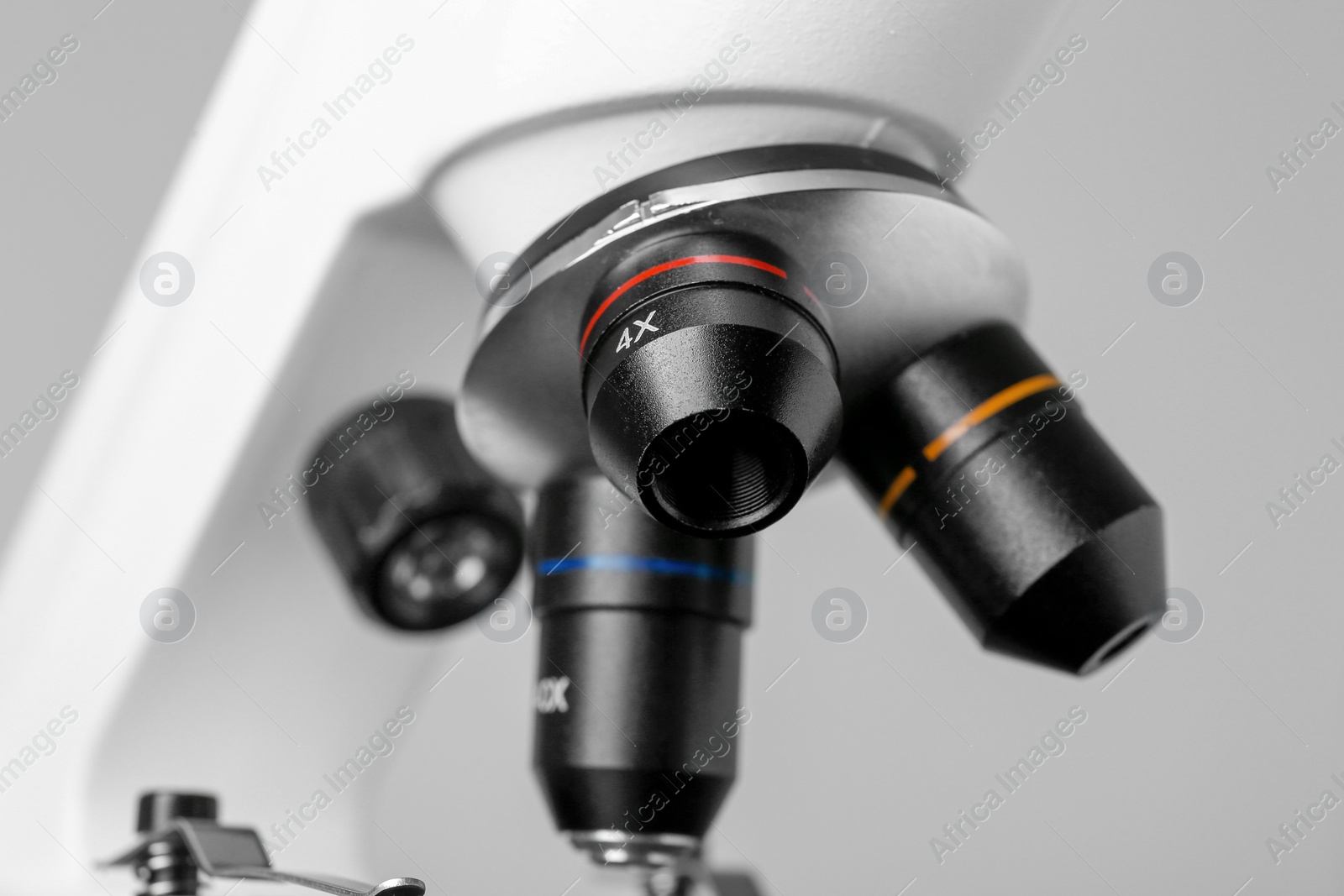 Photo of Closeup view of modern medical microscope on grey background