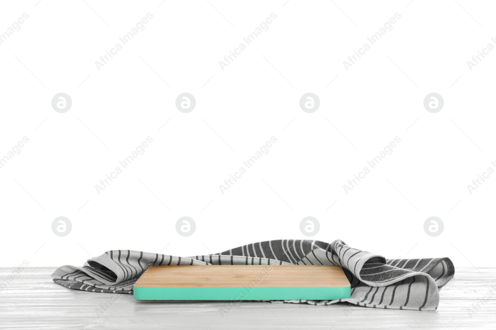 Photo of Wooden board and napkin on table against white background