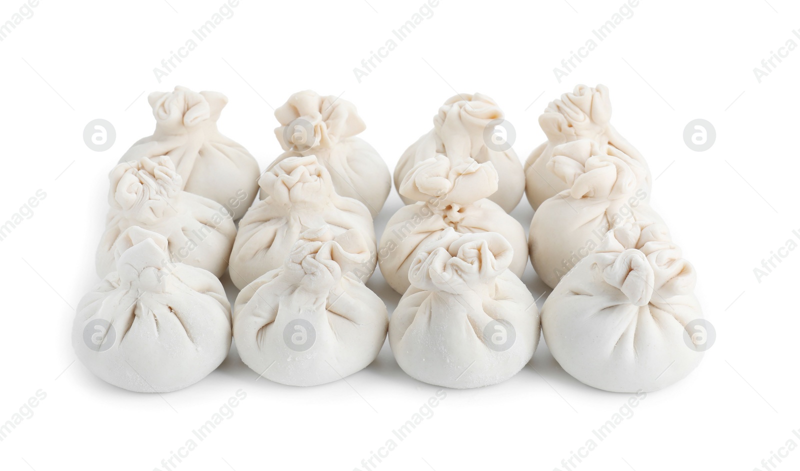 Photo of Many uncooked khinkali (dumplings) isolated on white. Georgian cuisine