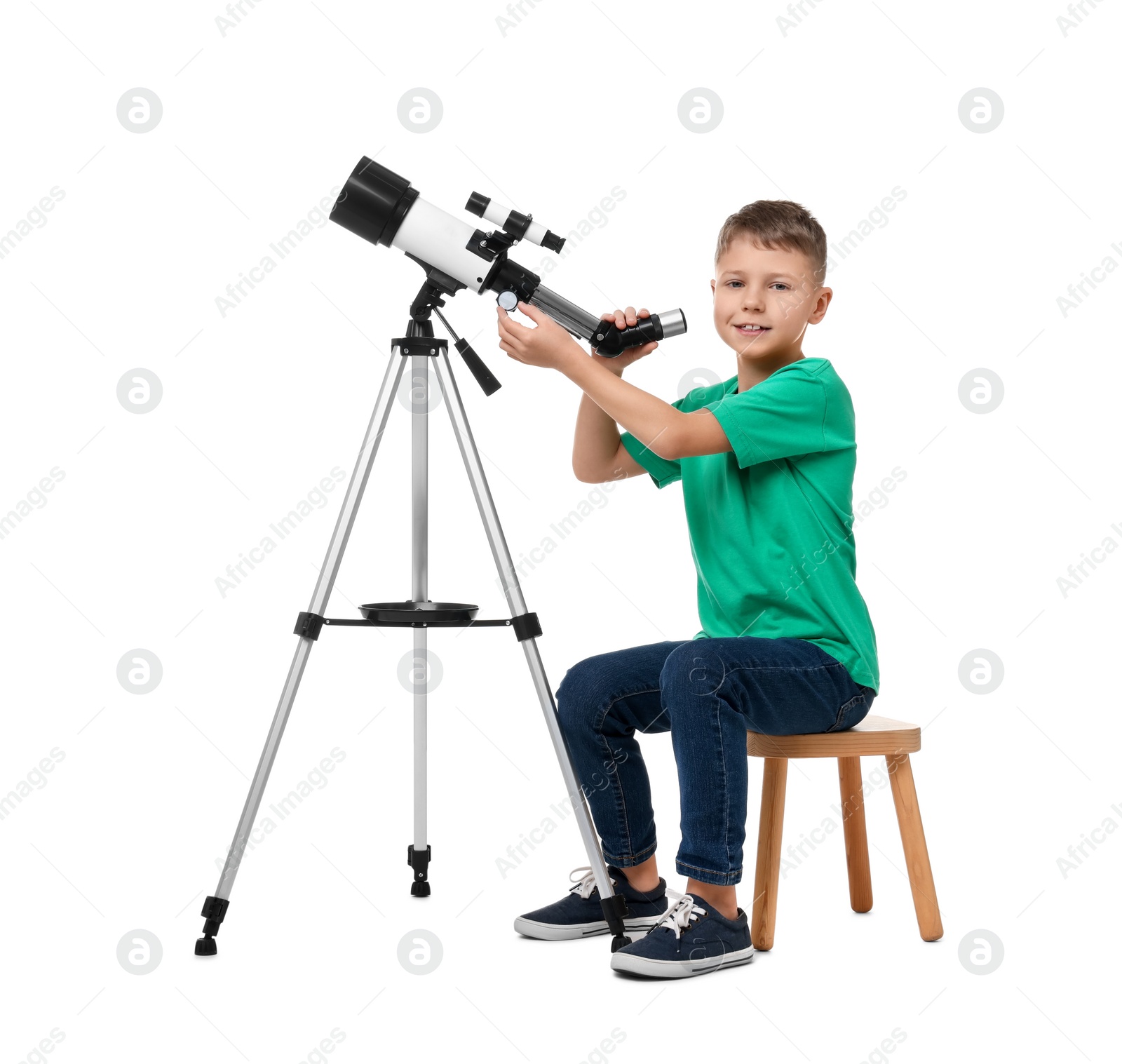Photo of Happy little boy with telescope on white background