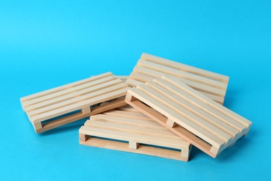 Pile of wooden pallets on light blue background