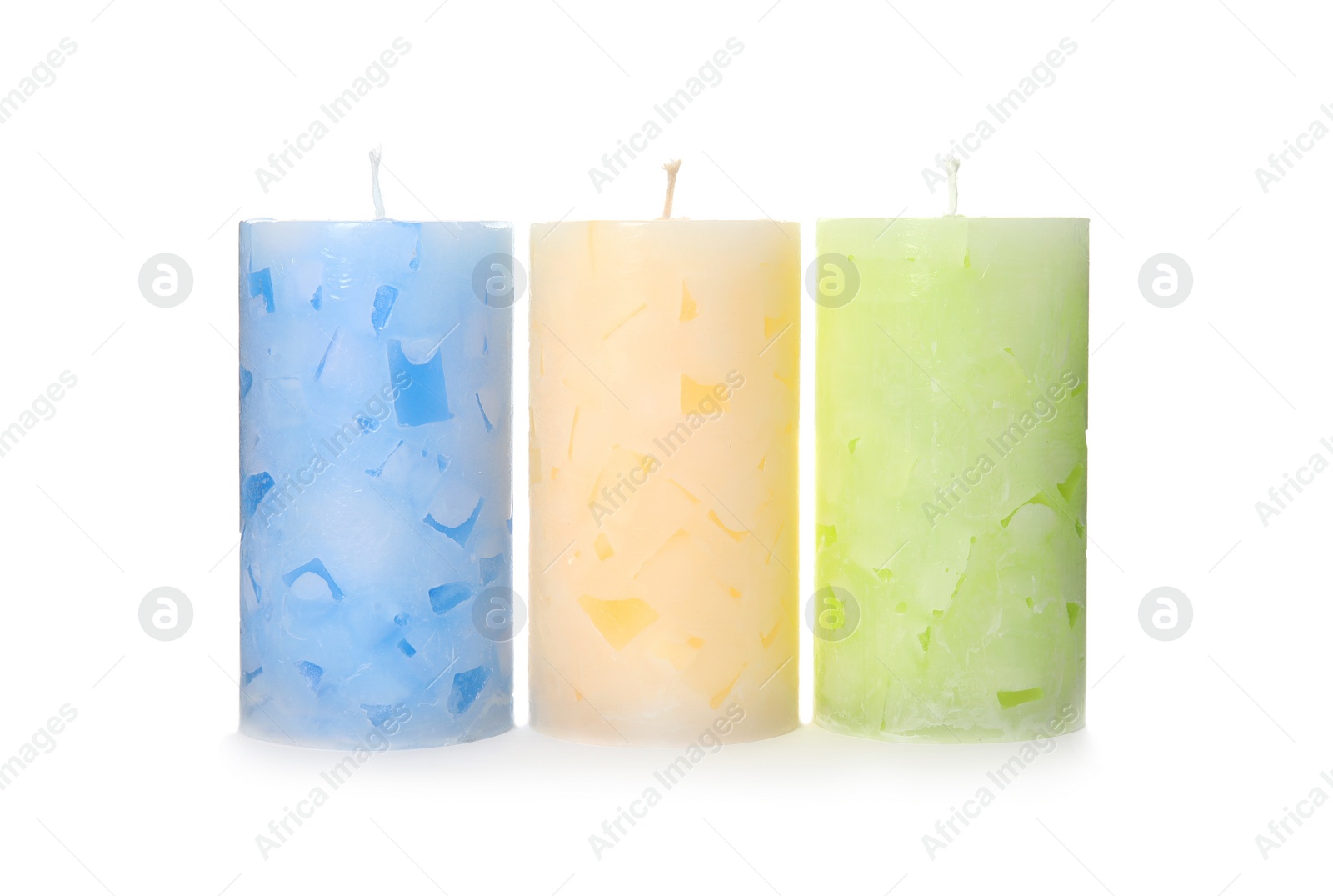 Photo of Three color wax candles on white background