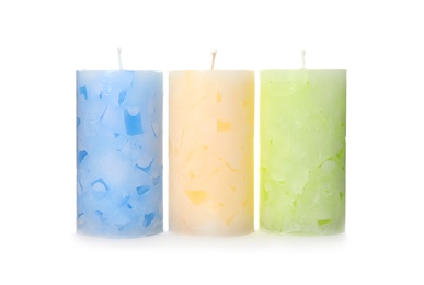 Photo of Three color wax candles on white background