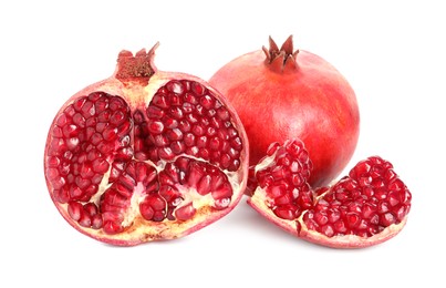 Photo of Cut and whole pomegranates isolated on white