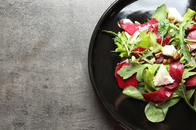 Plate with delicious beet salad on grey background, top view