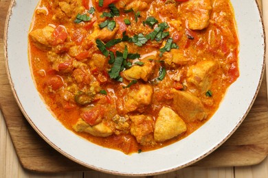 Photo of Delicious chicken curry on table, top view