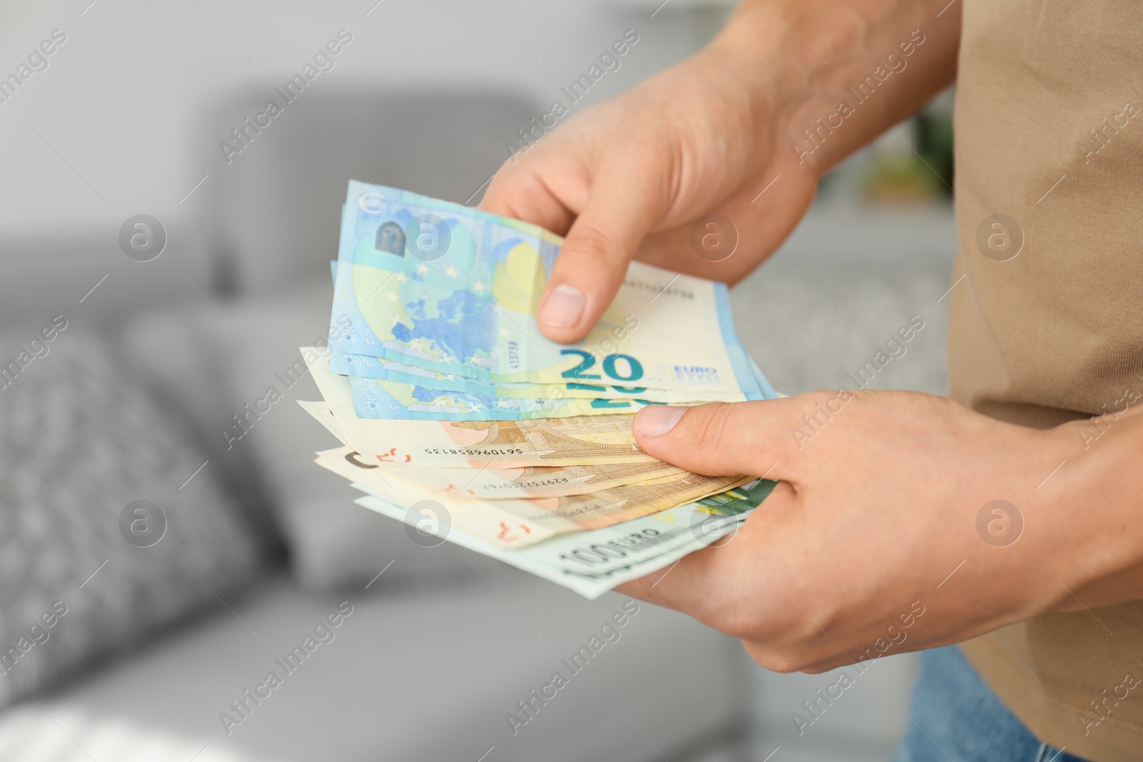 Photo of Man with Euro banknotes in room, closeup