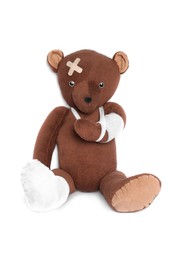 Photo of Toy bear with bandages isolated on white