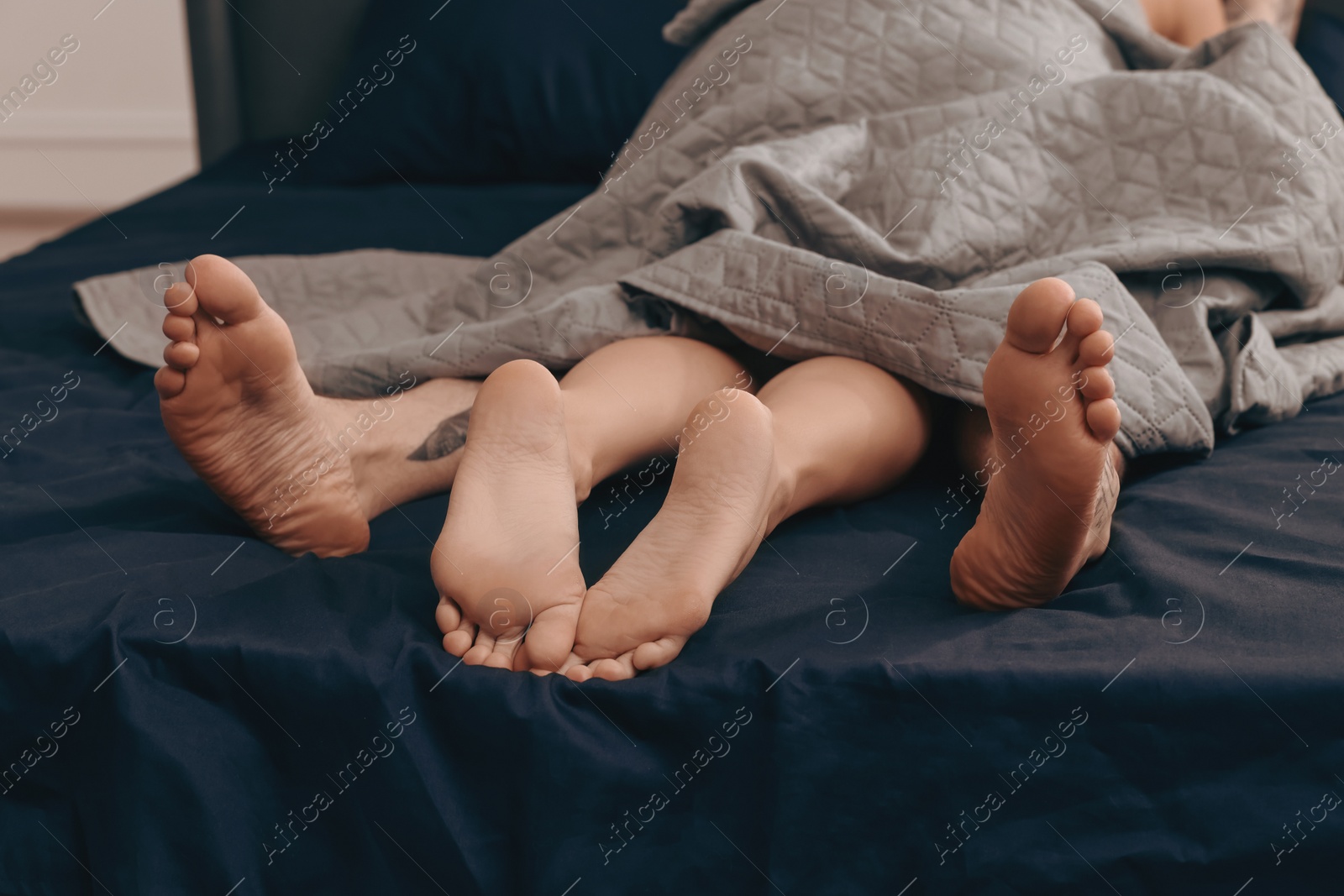 Photo of Passionate couple having sex on bed, closeup