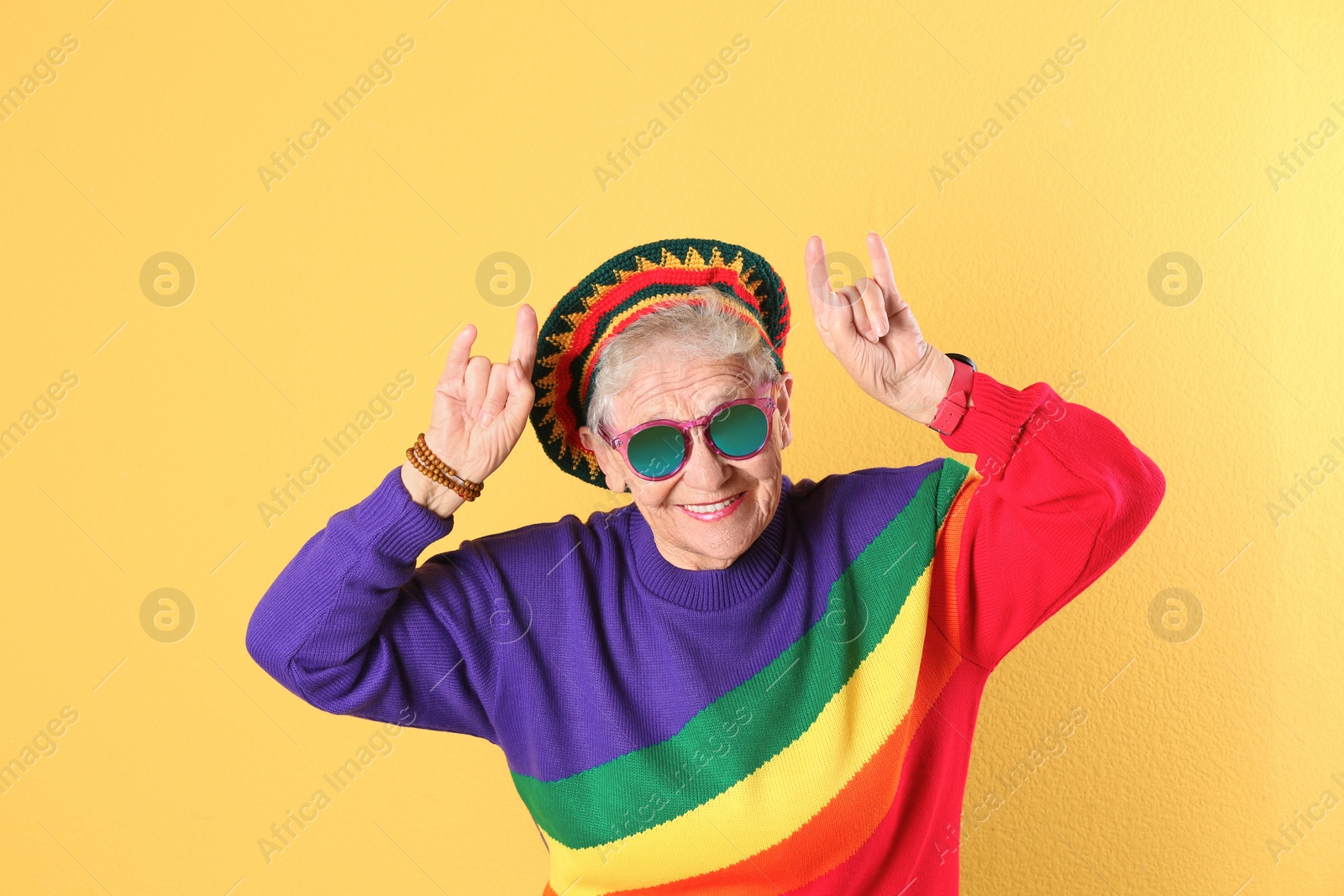 Photo of Portrait of cool grandmother on color background