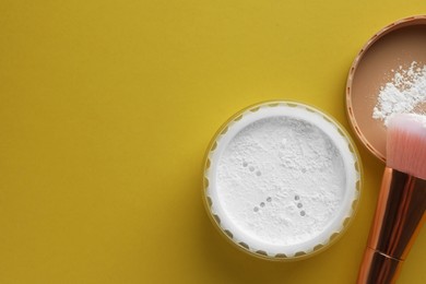 Photo of Rice loose face powder and makeup brush on yellow background, flat lay. Space for text