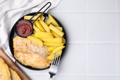 Delicious fish and chips served on white tiled table, flat lay. Space for text