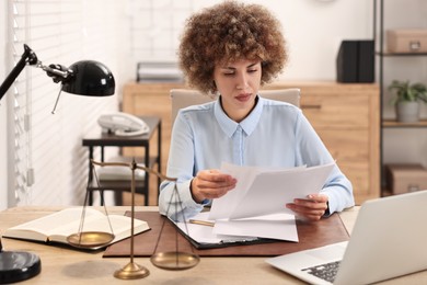 Notary working with documents at workplace in office