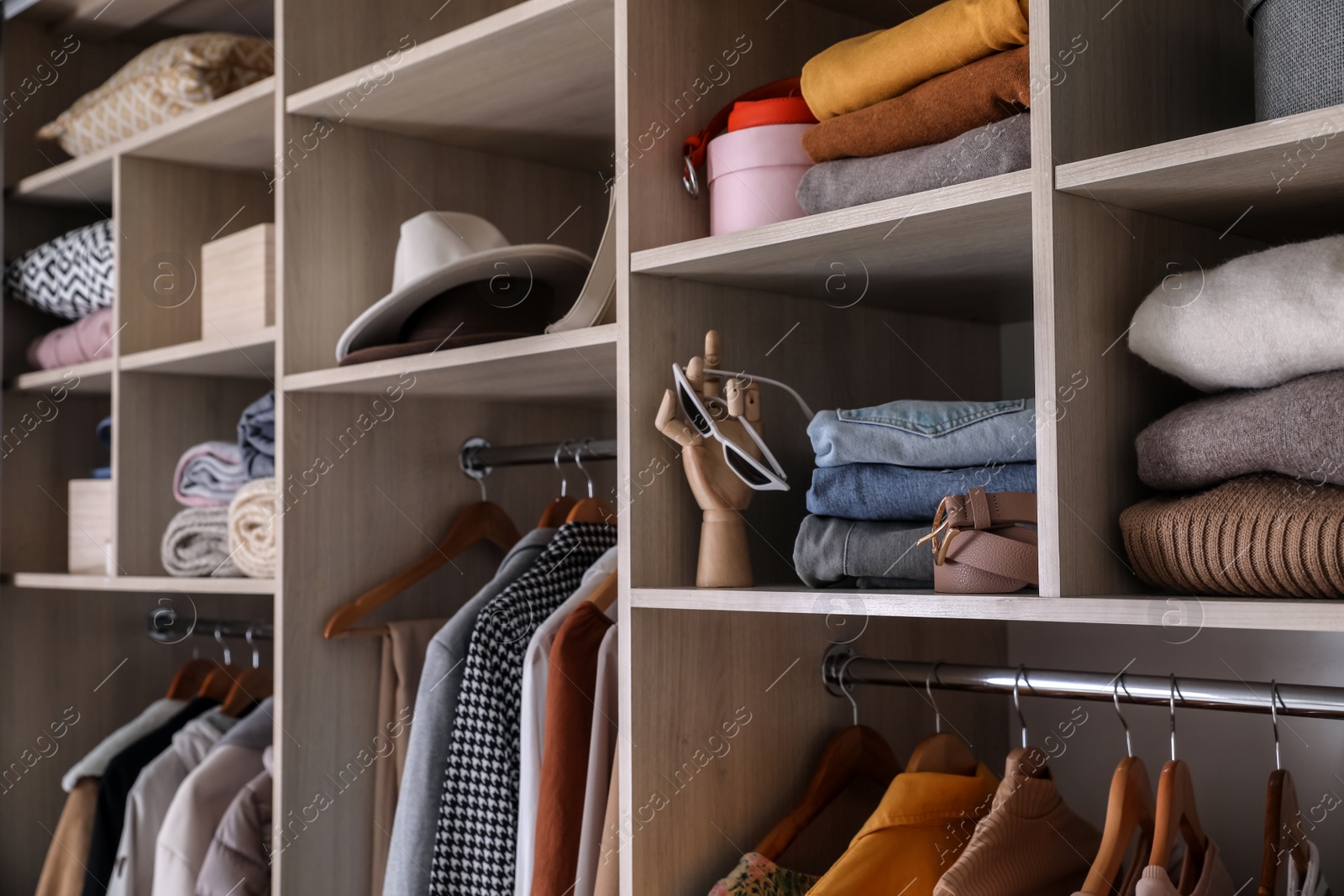 Photo of Wardrobe closet with different stylish clothes, accessories and home stuff