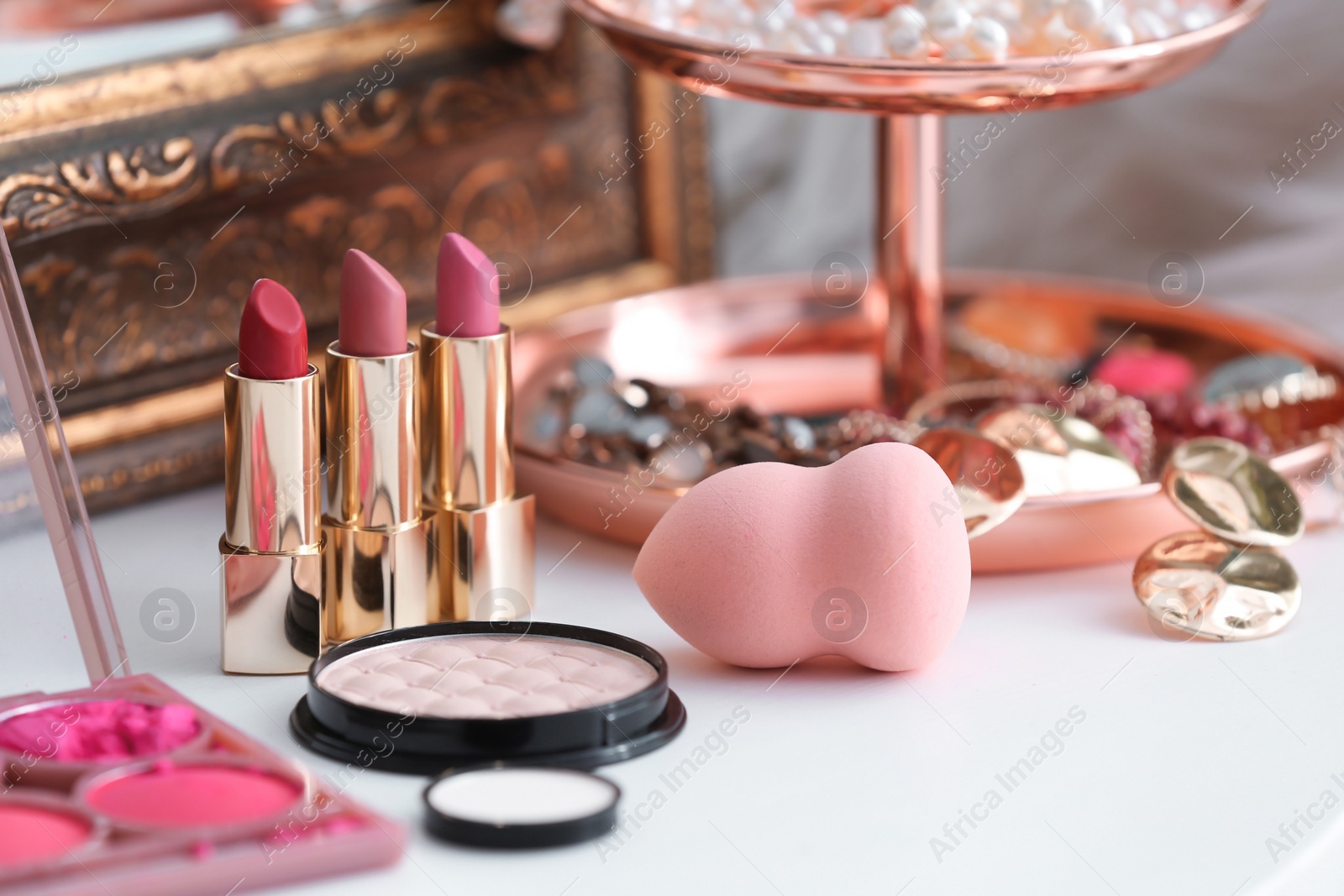 Photo of Decorative cosmetics on dressing table in makeup room