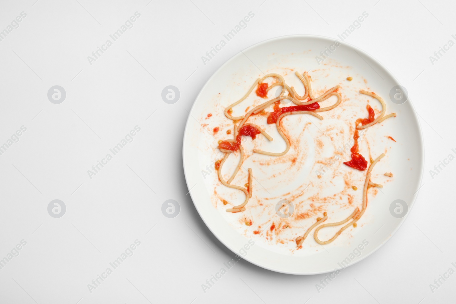 Photo of Dirty plate with food leftovers on white background, top view