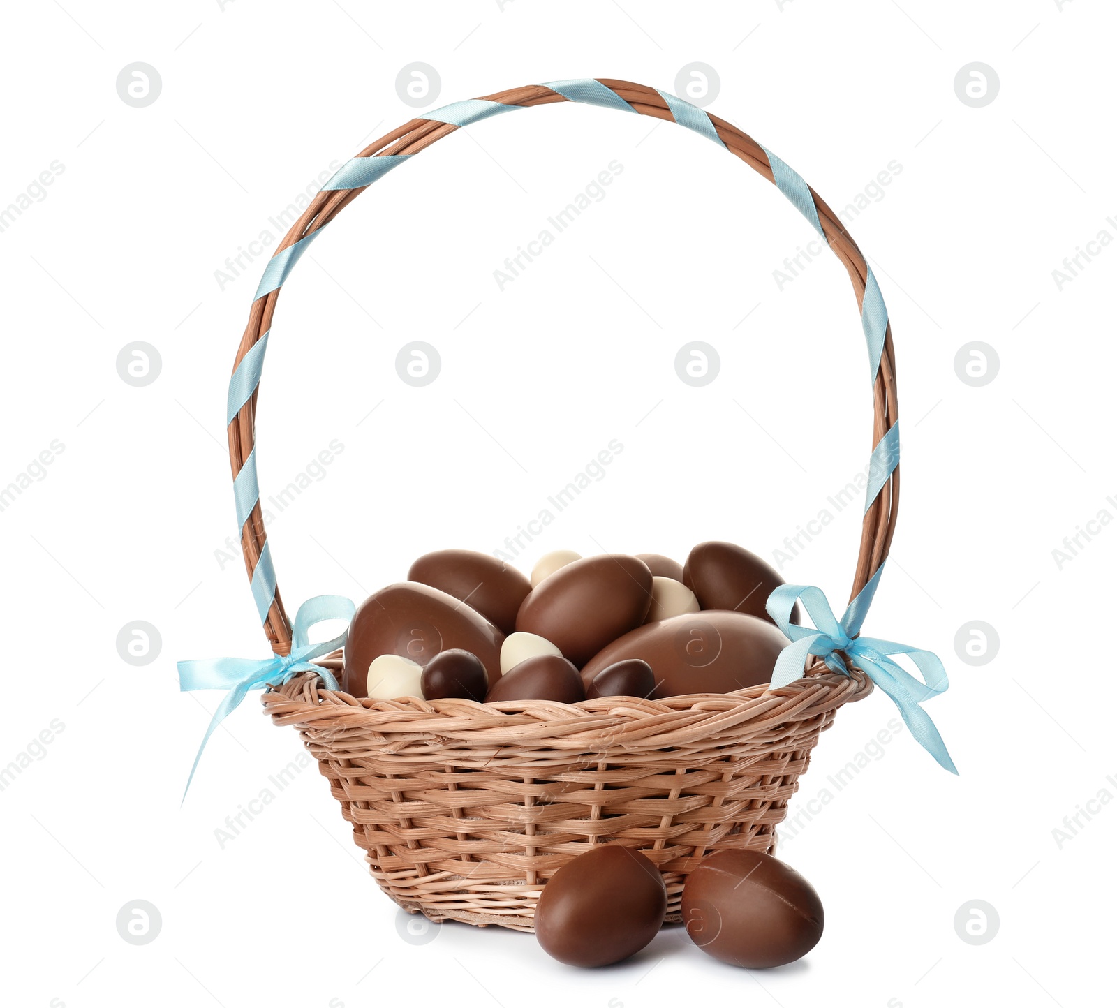 Photo of Wicker basket with chocolate Easter eggs on white background