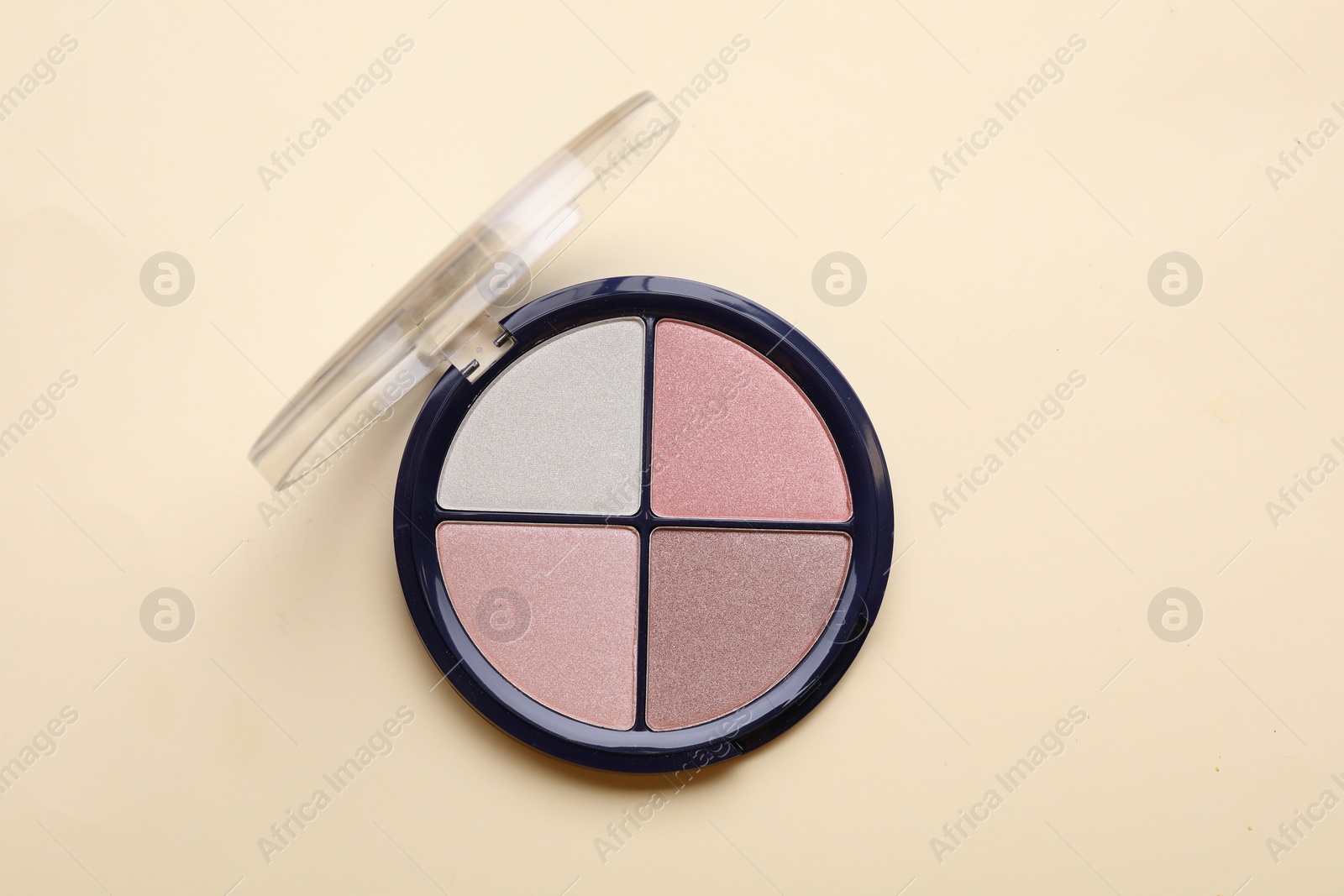 Photo of Colorful contouring palette on beige background, top view. Professional cosmetic product