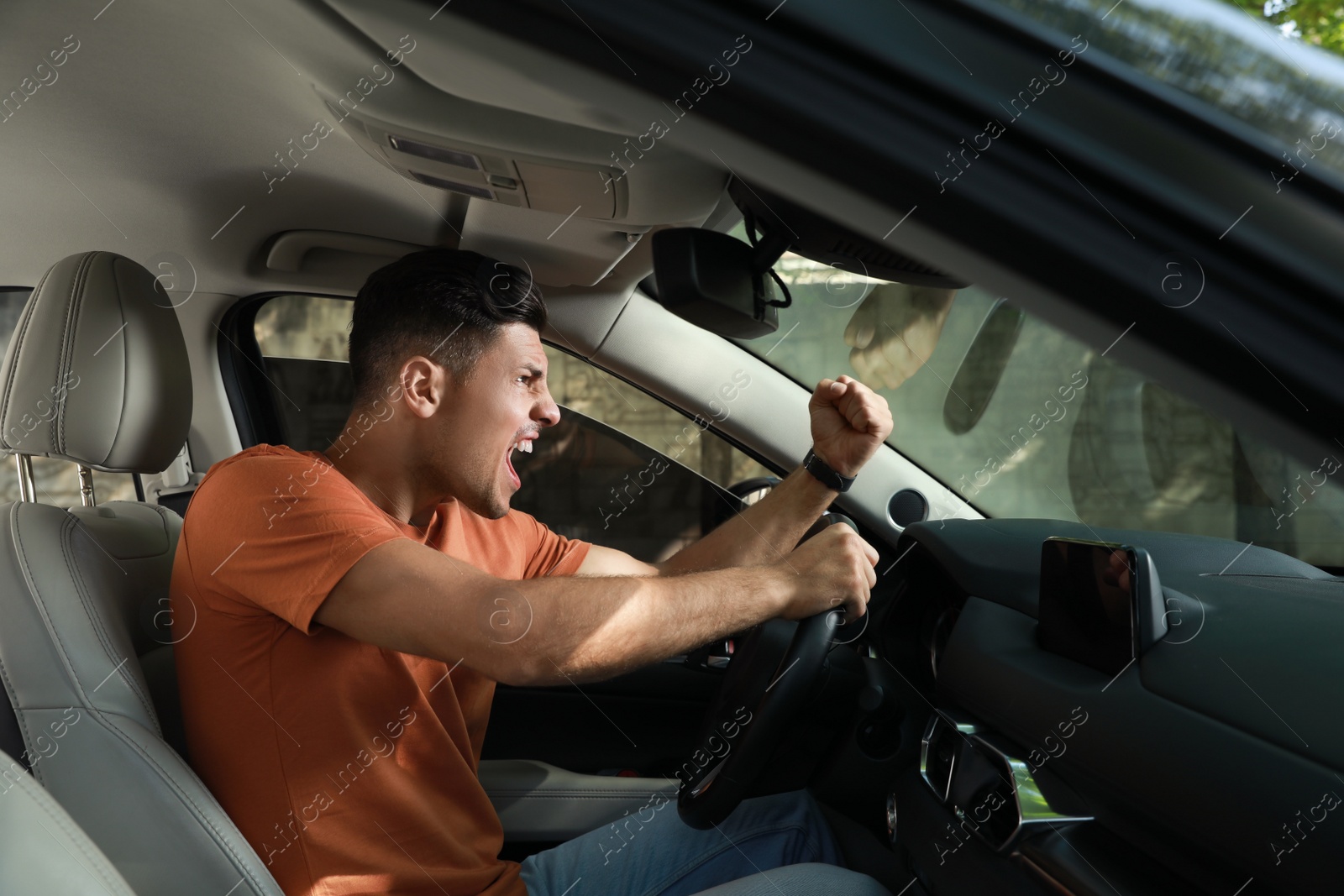 Photo of Stressed man in driver's seat of modern car