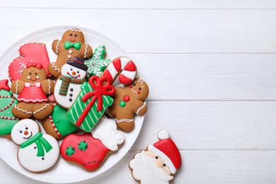 Delicious Christmas cookies on white wooden table, flat lay. Space for text