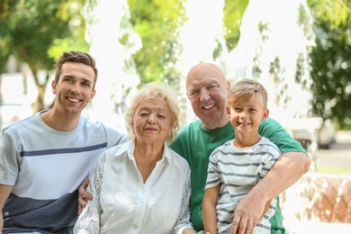 Photo of Man with son and elderly parents outdoors