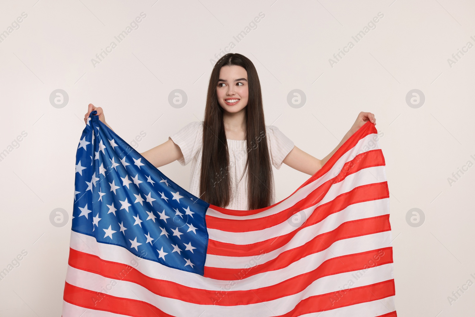 Photo of 4th of July - Independence Day of USA. Happy girl with American flag on white background