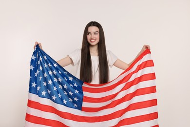 Photo of 4th of July - Independence Day of USA. Happy girl with American flag on white background