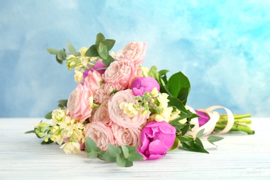 Photo of Bouquet of beautiful fragrant flowers on table