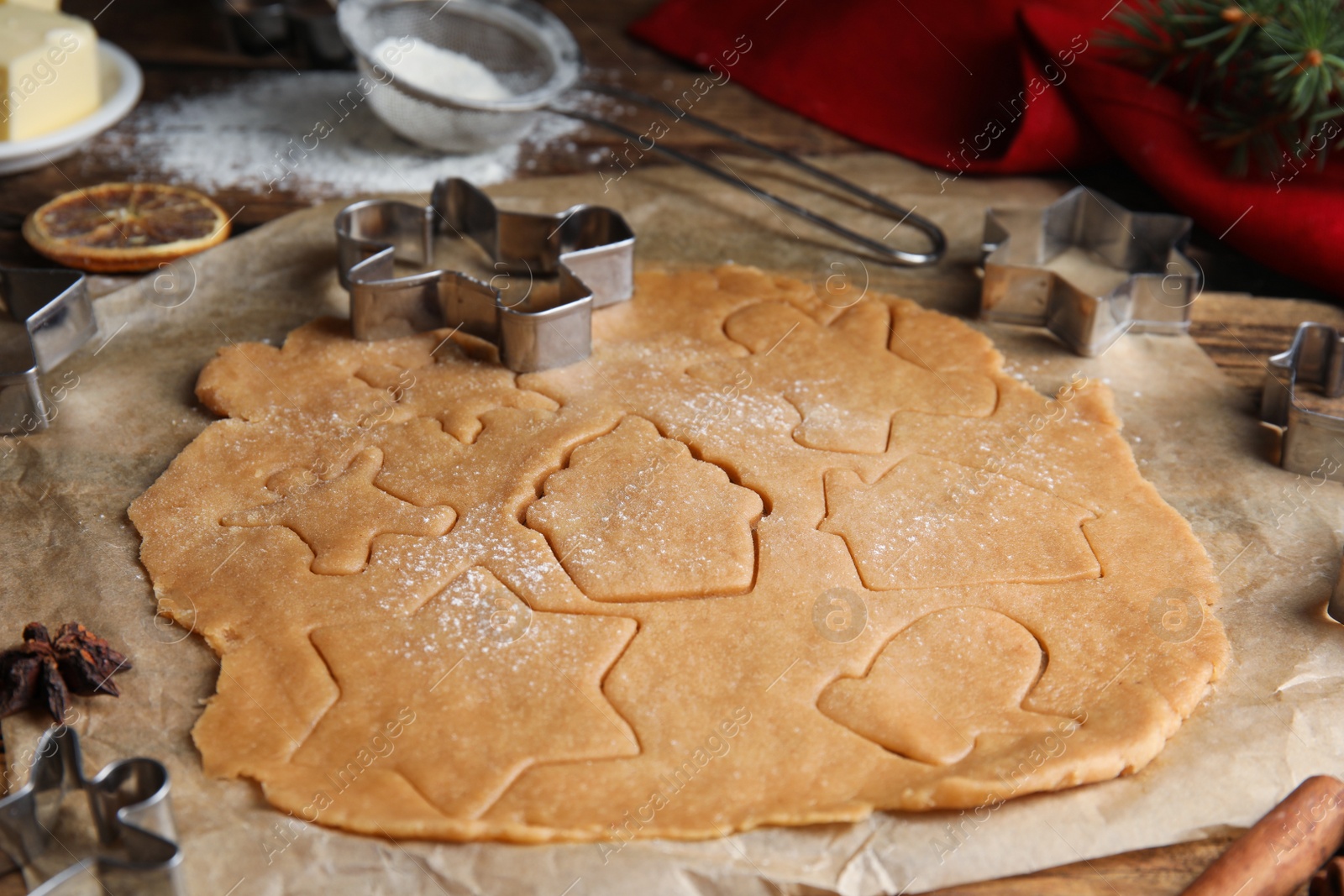 Photo of Making homemade Christmas cookies. Dough and cutters on table, closeup