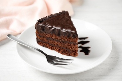 Tasty chocolate cake served on white wooden table