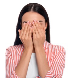 Embarrassed young woman covering face with hands on white background