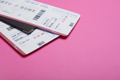Photo of Tickets and passport on pink background, space for text. Travel agency concept