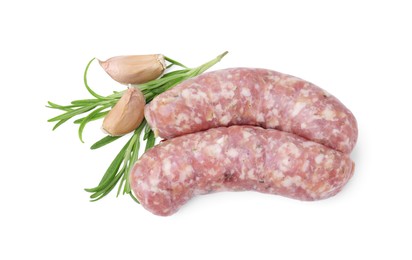Photo of Raw homemade sausages, rosemary and garlic isolated on white, top view