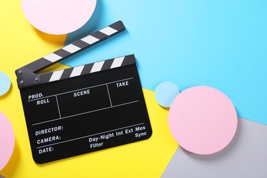 Photo of Clapperboard on color background, top view. Space for text