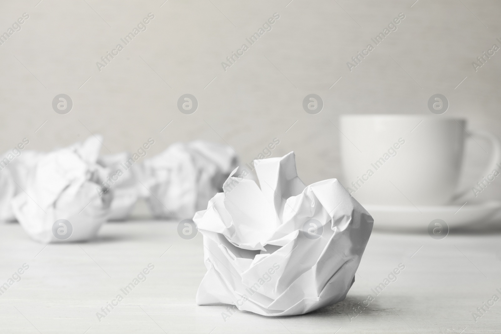 Photo of Ball of crumpled paper on white table