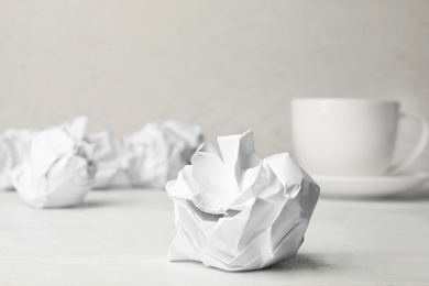 Ball of crumpled paper on white table