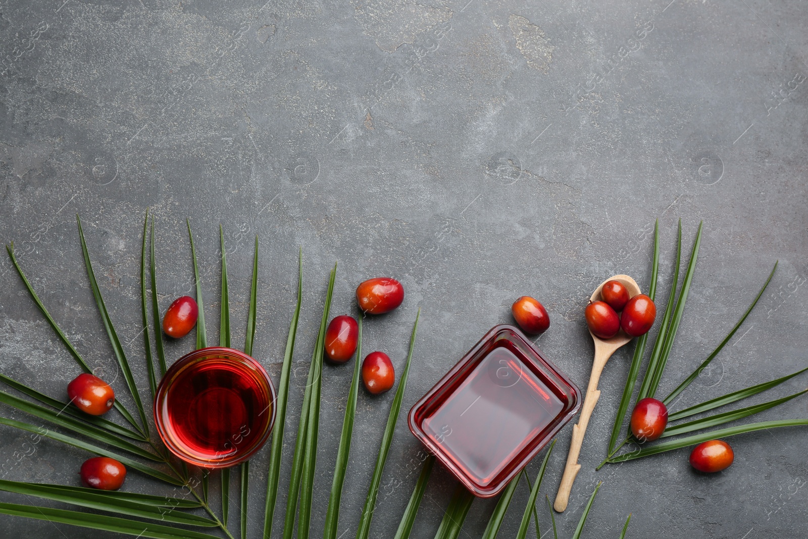 Photo of Flat lay composition with palm oil and fresh fruits on grey table. Space for text