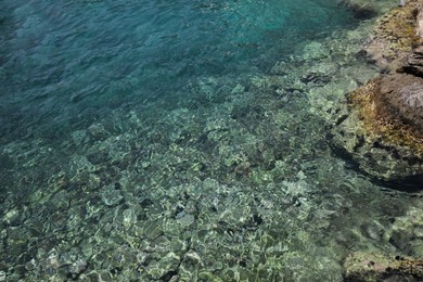 Shallow water with rocky sea bottom as background