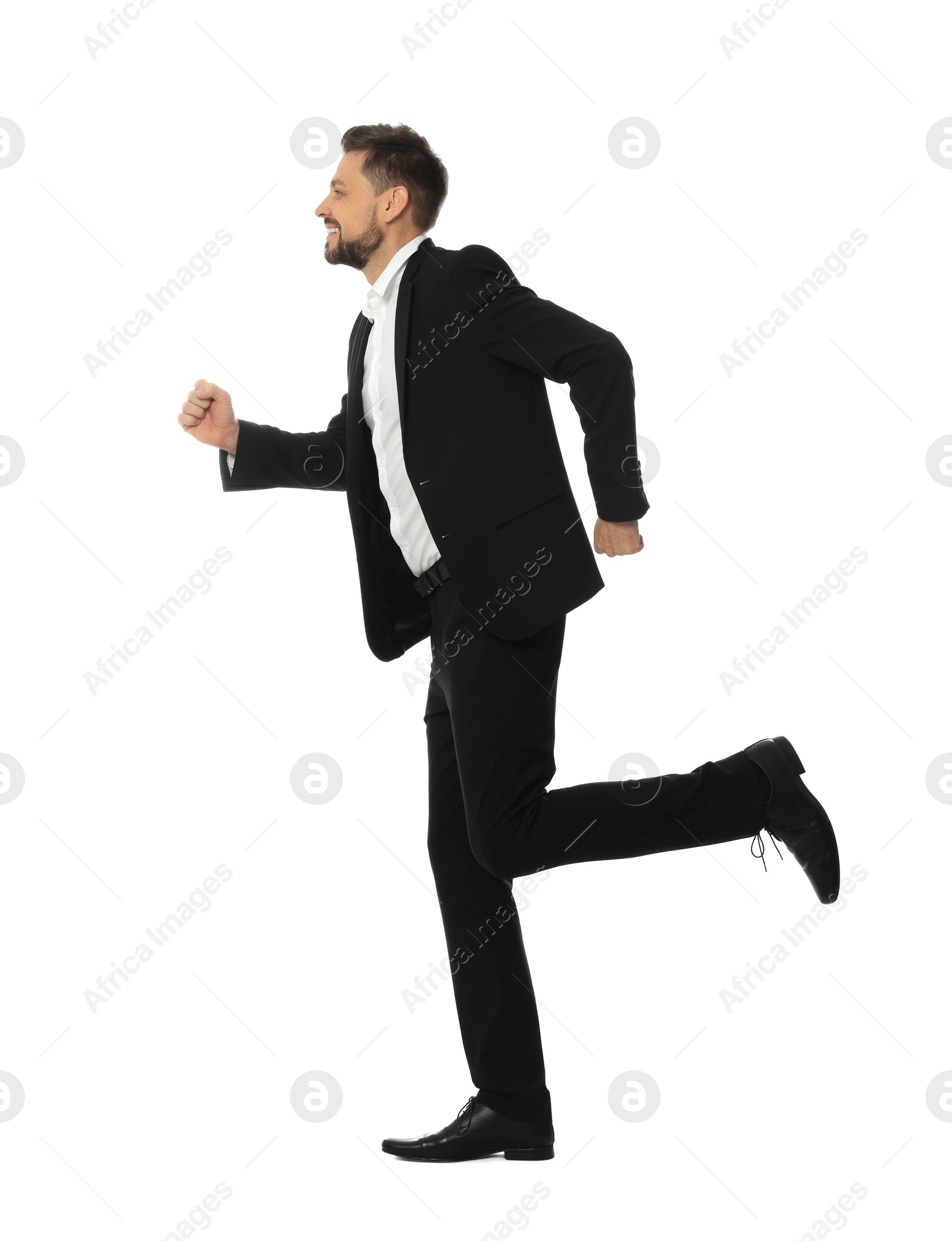 Photo of Handsome bearded businessman in suit running on white background
