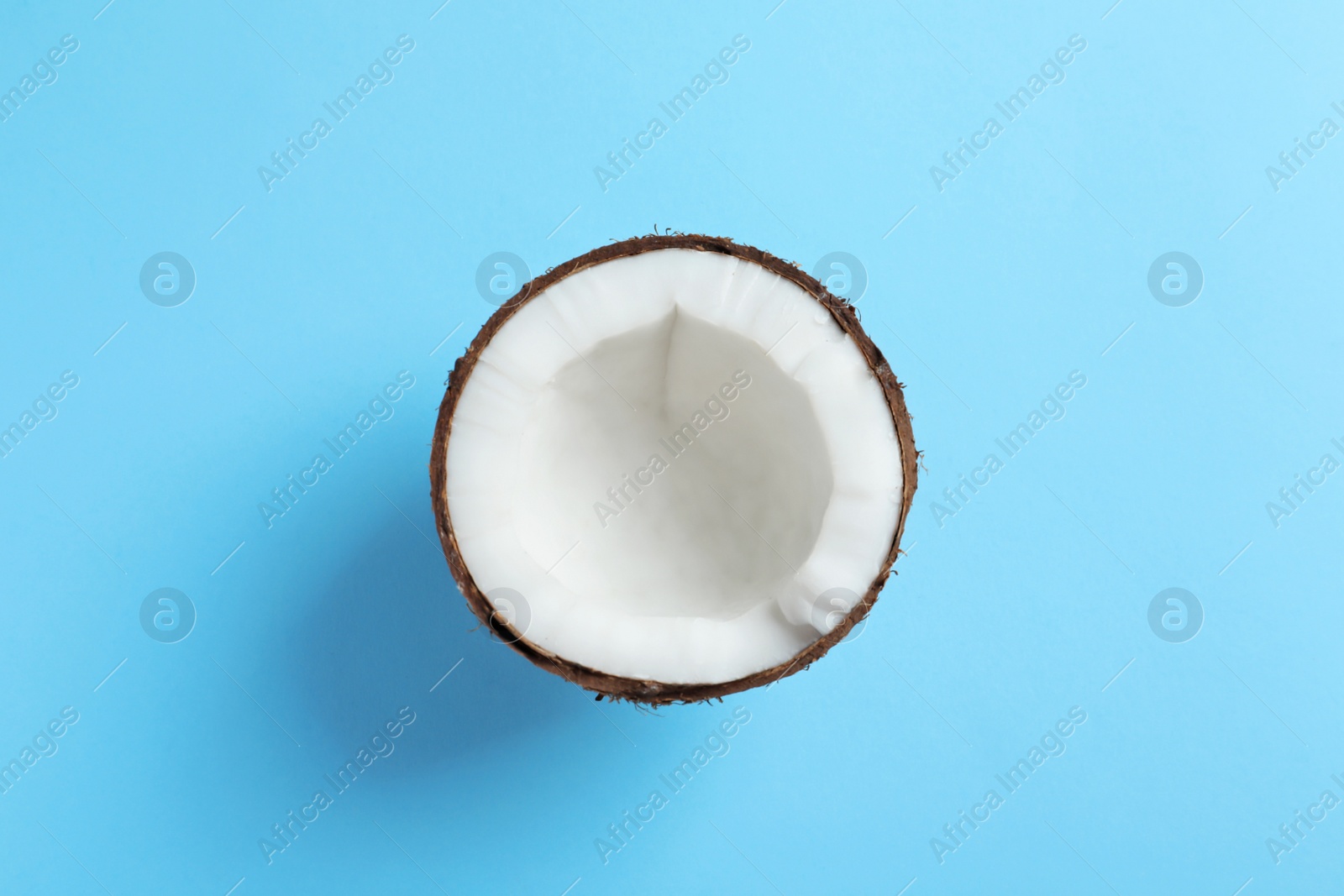 Photo of Half of coconut on color background, top view